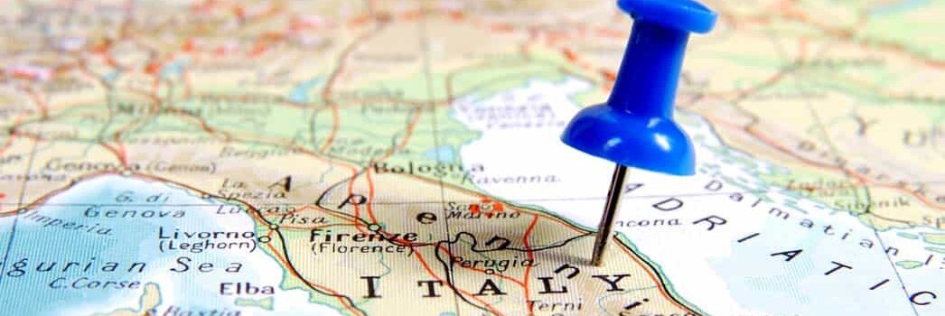 Blue pin stuck in Italy map