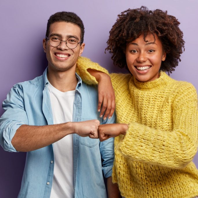 Young,Diverse,Couple,Give,Fist,Bump,,Agree,To,Bring,Plan